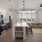 Kitchen with open living room with sunlit windows and open shelves in island