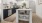 Cook in style with Electrolux stainless steel appliances, wood-style plank flooring, and elegant tile backsplashes.