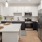 Cook in style with Electrolux stainless steel appliances, wood-style plank flooring, and elegant tile backsplashes.